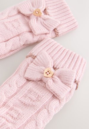 Šviesiai rožinės megztos pirštinės su ribotu rankogaliu, puoštos didele kaspino dekoracija ir auksinės širdies formos detalėmis su gėlių išpjova.