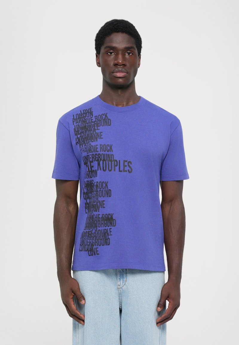 Purple cotton t-shirt with short sleeves, featuring bold black text arranged diagonally, displaying various words and phrases.
