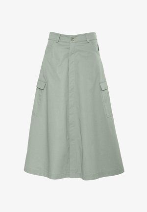 Világos zöld midi szoknya, amely pamutból készült, gombos záródással, két oldalsó zsebbel és egyenes sziluettel. Egyszerű, letisztult dizájn jellemzi.