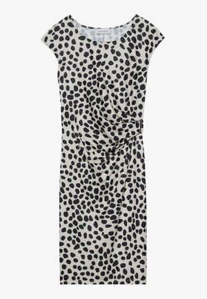Knee-length dress in light beige with a black spotted pattern, featuring short cap sleeves and a side draping detail secured with a metallic accent.