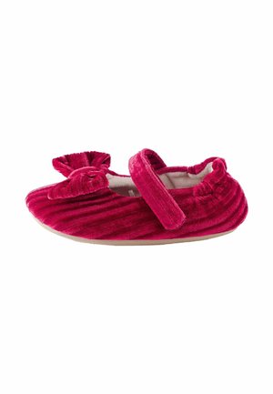 Soft red velvet baby shoe with a bow on the front and a single adjustable strap across the top.