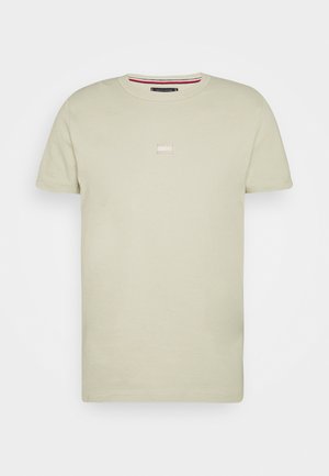 Light green cotton T-shirt with a round neckline, short sleeves, and a small rectangular logo in the center. Smooth texture, casual design.