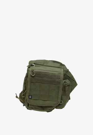 Grüne taktische Tasche aus strapazierfähigem Material, ausgestattet mit mehreren Reißverschlussfächern, einem Netztaschen und Gurtband für Anbringungsmöglichkeiten.