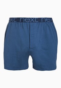 Boxeri din bumbac albastru cu talie elastică, având logo-ul "next". Un singur nasture de închidere este vizibil în față, cu o textură netedă.
