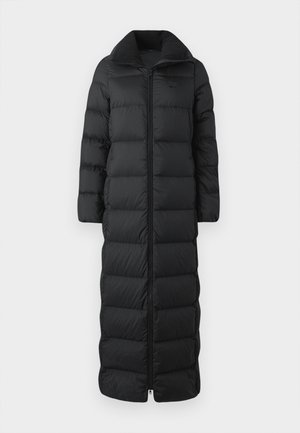 Long black puffer coat with a high collar, featuring horizontal quilted sections and a front zipper. Material appears smooth and insulated.