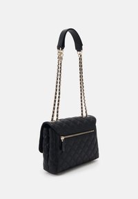 Black quilted handbag with a gold chain strap and black leather accents. Features a front zipper pocket and a structured shape.