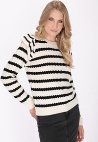 Zwart en crèmekleurig gestreepte sweater van textuurstof met rimpelige schouderaccenten. Ribbelboorden en -zoom, met een klassiek ronde hals ontwerp.
