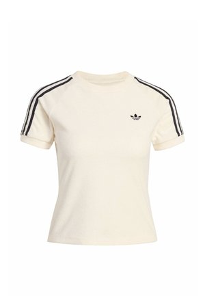 Krémová mikina s krátkym rukávom a čiernymi pruhovými akcentmi na pleciach a malým čiernym logom na hrudi. Mäkko štruktúrovaná terry látka.