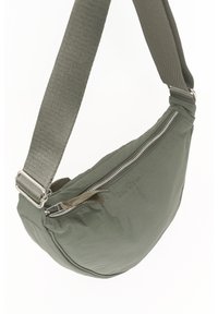 Borsa a tracolla verde in tessuto con forma curva, dotata di una cerniera argentata e di una tracolla regolabile. Logo "Part Two" impresso sul lato.