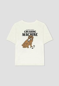 Camiseta de algodón en color blanco roto con un perro de dibujos animados, el texto "KAOTIKO SOCIETY CRUSHING MACHINE" y acentos negros en el diseño.