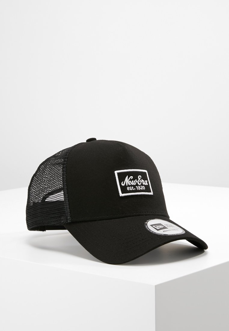 Black baseball cap made of fabric with a mesh back, featuring a white logo patch that reads "New Era est. 1920" on the front.