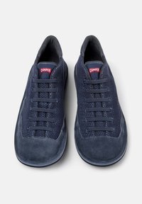 Navy blue shoes with a combination of suede and mesh material, featuring a rounded toe, six lace eyelets, and a red brand tag on the tongue.
