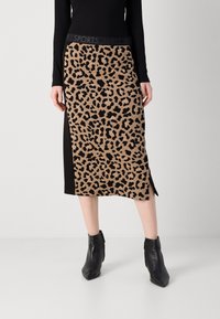 Gonna lunghezza ginocchio con stampa leopardo in marrone e nero, caratterizzata da uno spacco laterale e una vita aderente nera con testo del logo.