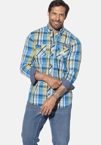 Blue and yellow plaid shirt with long sleeves, button-down collar, chest pockets, and dark denim accents. Cotton fabric, breathable texture.