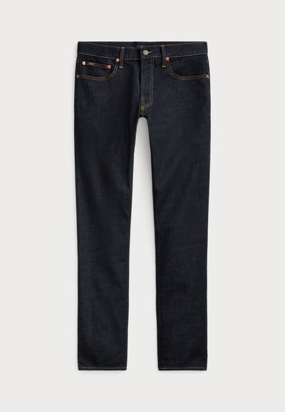 Mørke denimjeans med slim fit, i kontrastfarge oransjetråd, fem lommer, og klassisk fem-knapp-lukking foran.