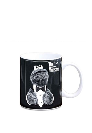 White mug with black background featuring a furry character wearing a tuxedo and bow tie, with the text "The Monster" on the side.