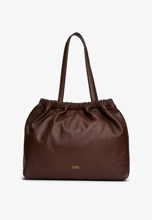 Dark brown soft leather tote bag with gathered top edge and double shoulder straps, small gold "Tommy Hilfiger" logo on front.