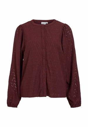 Ilgas rankovėmis užsegamas marškinėlių tipo palaidinė iš bordo spalvos nėrinių audinio su pūstomis rankovėmis ir apvalia iškirpte.