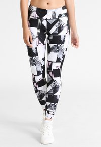 Tajta leggings med geometriska mönster i svart, vitt och rosa. Tillverkade av elastisk tyg, med hög midja och slank design.