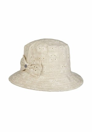 Beige bucket hat with embroidered eyelet floral patterns and a fabric bow on the side featuring a small round metal tag.
