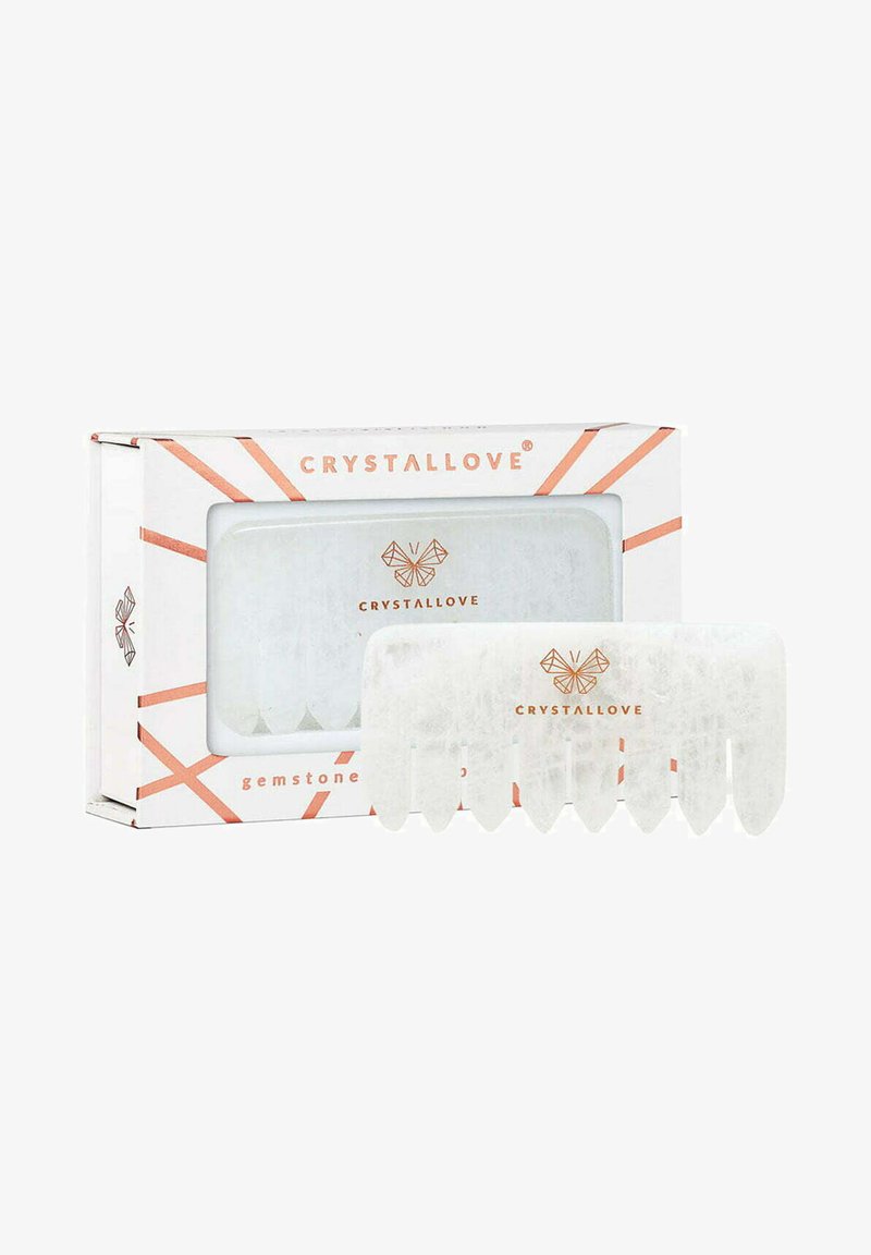 Peigne à cheveux en cristal de pierre blanche, avec un design texturé, arborant un motif hexagonal et un emballage de marque en blanc et or rose.