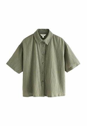 Chemise à manches courtes, à boutons, en tissu texturé vert clair. Présente un col et cinq boutons sur le devant. Coupe décontractée avec une apparence douce.