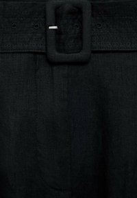Black linen belt with a large rectangular buckle, featuring a textured fabric and visible stitching along the strap.