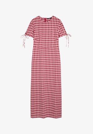 Czerwona i biała sukienka w kratę z krótkimi rękawami, wiązaniami na ramionach, okrągłym dekoltem i długości maxi. Wykonana z miękkiego, lekkiego materiału.