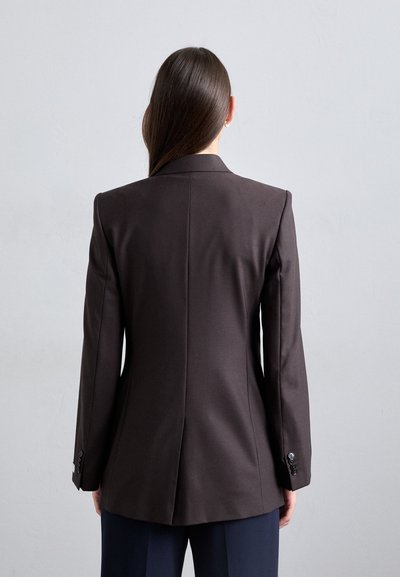 Brown tailored blazer with a fitted shape, single vent, and buttoned cuffs. Smooth fabric and structured design, viewed from the back.