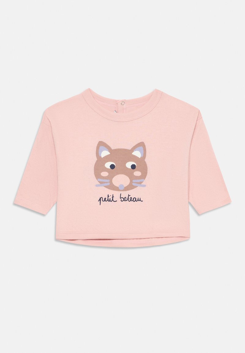 T-shirt rosa chiaro a maniche corte realizzato in tessuto morbido. Presenta un volto di animale cartoon e la scritta "petit bateau" in blu scuro sottostante.