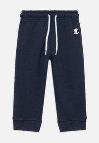Marineblå sweatpants med snoreliv, tætsiddende ben og ribbede manchetter. Har et lille broderet logo på venstre lår. Blød tekstur.