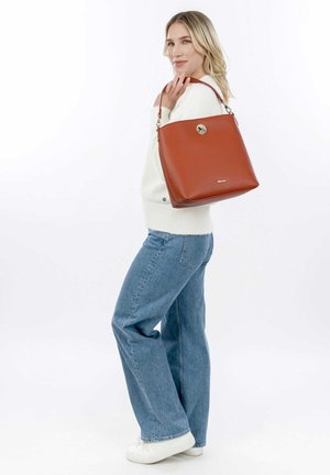 Brown leather bucket bag with a textured surface and a metal clasp, featuring a single shoulder strap and a gold-tone accent.