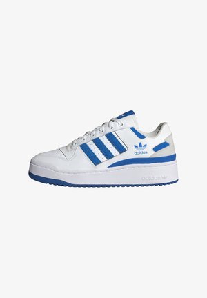 Baskets blanches Adidas avec des bandes bleues, bord de semelle bleu et logo sur le côté et la languette, vues de l’extérieur.