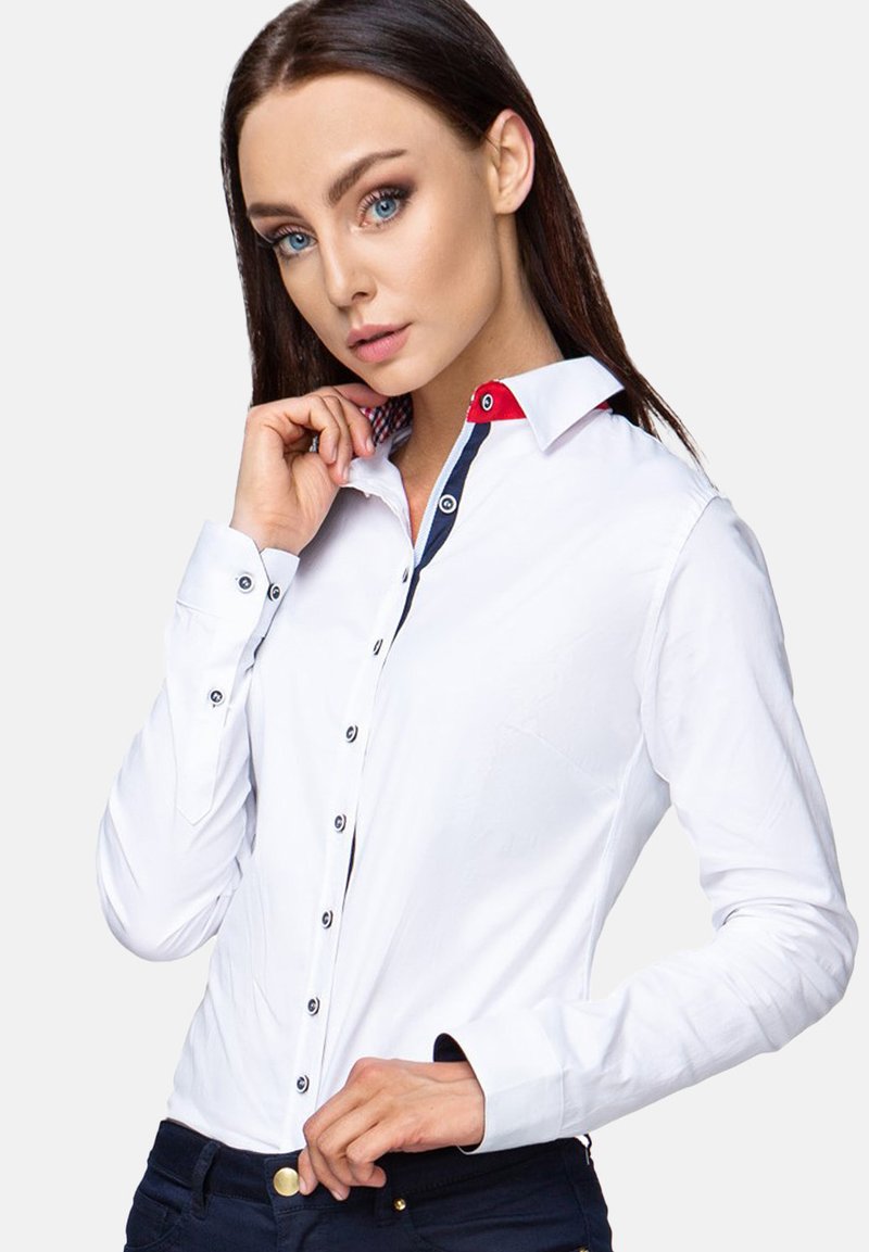 White long-sleeve shirt with a red accent on the collar, navy button details, and a fitted design, made of smooth fabric.