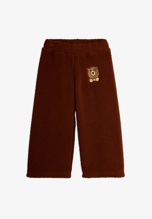 Calças de flanela castanhas com uma superfície suave e texturada. Apresentam um motivo de urso bordado na frente. Cintura elástica para maior conforto.