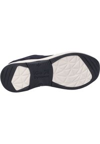 Schuhsohle mit einem strukturierten schwarzen Gummibereich mit geometrischen Mustern, beschriftet "iGo Dynamic", und einer kontrastierenden weißen Zwischensohle.