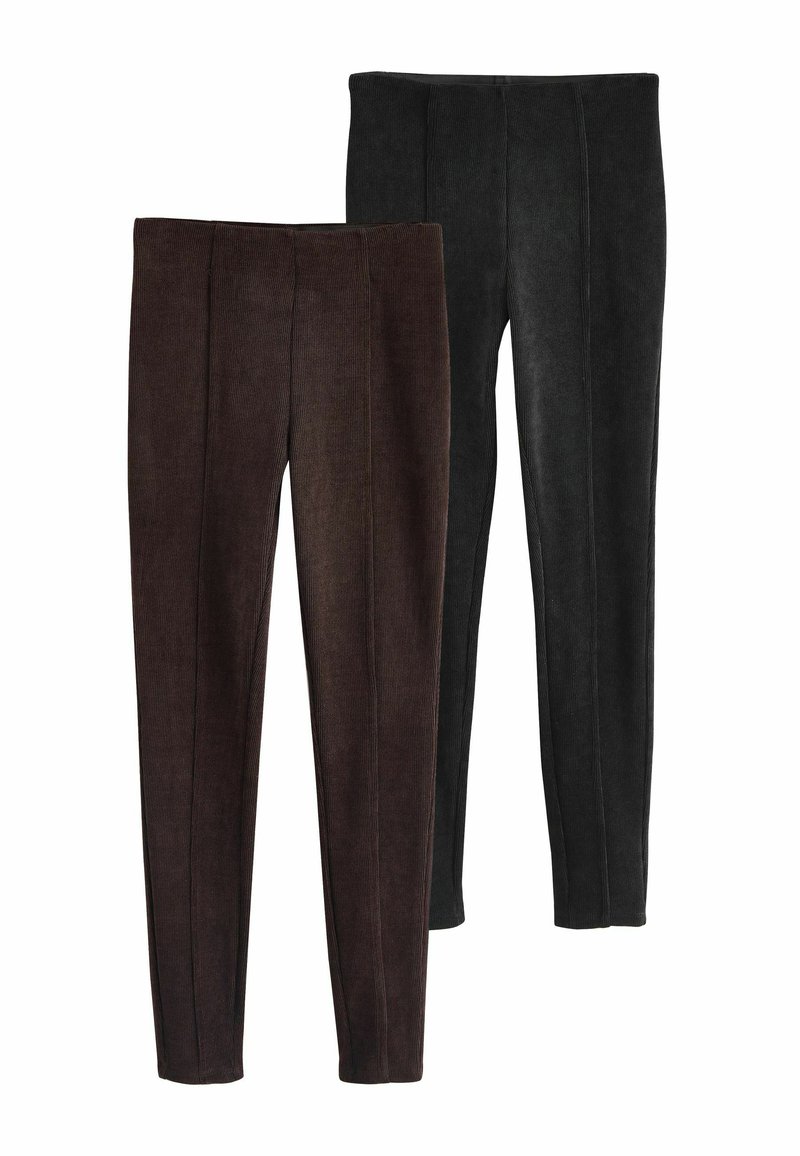 Ett par leggings i mörkbrun och svart. Har ribbat mönster och vertikala sömmar. Fitted siluett med elastisk midja.