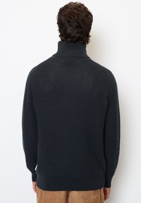 Dark navy pullover sweater with a high collar, textured knit pattern, ribbed cuffs and hem, and no visible branding or embellishments.