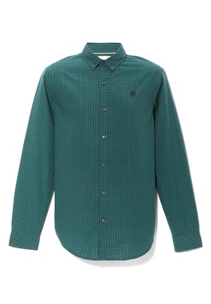 Chemise à carreaux verte et noire avec un col pointu, des manches longues et une fermeture à boutons sur le devant. Présente un petit logo sur la poitrine.