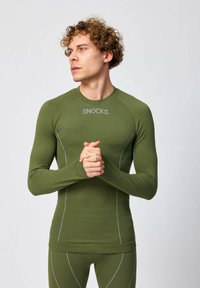 Olijfgroene shirt met lange mouwen van textuurstof, met het "SNOCKS"-logo en contrasterende grijze stiksels langs de naden. Aansluitende pasvorm.
