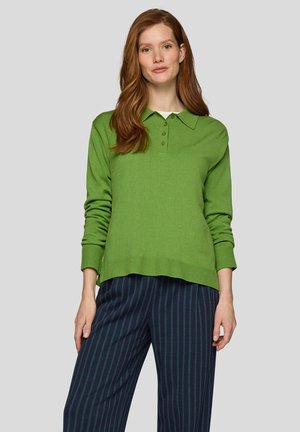 Grüner Langarm-Polo-Pullover mit Kragen, ausgestattet mit einem Knopfverschluss mit vier Knöpfen und gerippten Manschetten. Kombiniert mit marineblauen gestreiften weit geschnittenen Hosen.