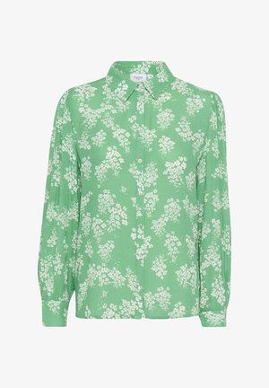 Roheline nööpidega särk, pikad varrukad, millel on valge lillemuster. Valmistatud kergest materjalist, kaelus on kraega.