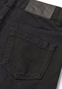 Pantaloni di denim neri con una tasca posteriore con cuciture dettagliate e un'etichetta in pelle testurizzata impresso con il nome del marchio "Molo."
