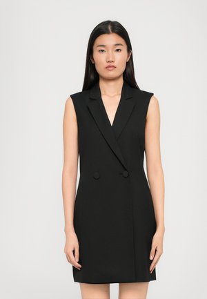 Black sleeveless blazer dress with a tailored fit, notch lapels, double-button closure, and smooth fabric texture.