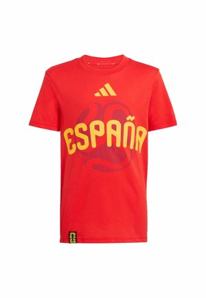 Red short-sleeve sports shirt with yellow "España" text, Adidas logo above, and a subtle dark graphic of a soccer ball behind the text.