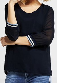 Navy blue blouse with a V-neck, three-quarter sleeves featuring white and light blue stripes. Lightweight fabric with a loose fit.