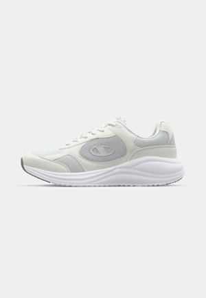 White athletic shoe with light gray accents, mesh and suede materials, rounded toe, textured sole, and visible branding logo on the side.