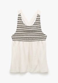 Ærmeløs top med et sort og hvidt stribet strikbælte og en let cremet, flowy bund. V-formet rygdesign.