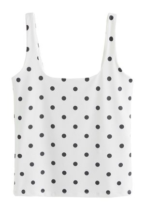 Hvid ærmeløs tanktop med sorte polkaprikker jævnt fordelt på stoffet og brede skulderstropper.