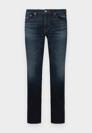 Donkerblauwe slim-fit jeans met lichte vervaging op de dijen en knieën, vijfzakkenontwerp en knoopsluiting in de taille.